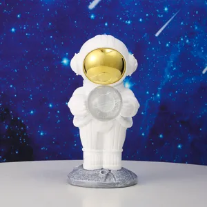 White astronaut figurine holding a crystal ball with a planet against a starry space background.