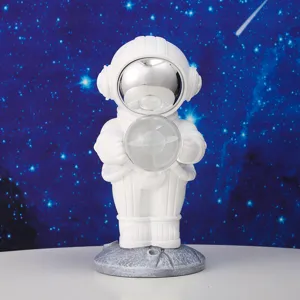 Detail shot of a white astronaut night light holding a crystal planet on a moon base