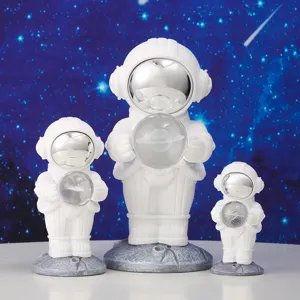 Three different sized astronaut night light ornaments for galaxy themed room decor