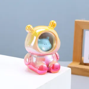 Detailed view of iridescent pearlescent ceramic hippo astronaut night light ornament