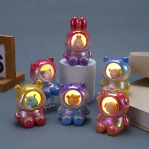 Detailed view of iridescent astronaut animal night lights with warm glowing faces