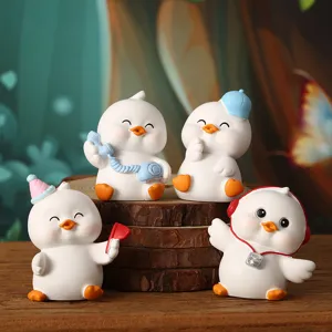Set of four cute white duck figurines with various accessories for desk decor