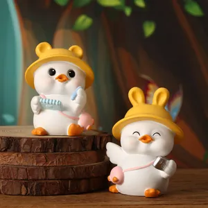 Close-up of two cute resin duck figurines wearing animal ear hats on natural wood base