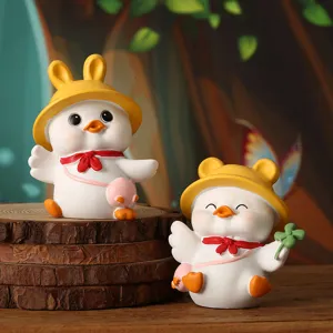 Macro detail of cute white duck figurines wearing yellow hats on wooden background
