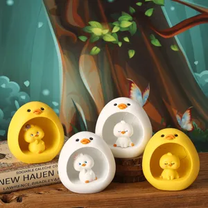 Detailed view of cute cartoon duck resin night lights on a rustic wooden base.