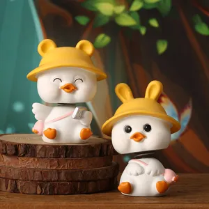 Pair of cute duck bobblehead figurines with bear and rabbit hats for car decor