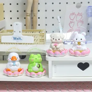 Set of four cute Zen animal figurines on pink lotus bases for office desktop decoration
