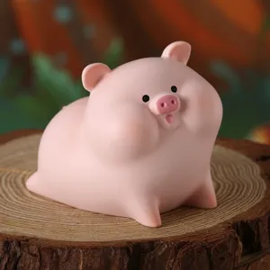 Primo piano di una simpatica statuina di maiale in resina rosa su una base di legno naturale.