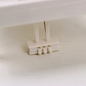 Macro detail showing the white plastic mechanical winding part of a rotating music box