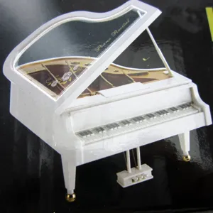 Detailed view of elegant white grand piano music box with Piano Recital text on the lid