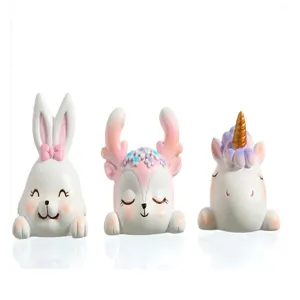 Detailed view of three cute resin animal figurines including a unicorn, rabbit, and deer.