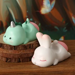Close-up detail of cute resin animal phone holders in rabbit and unicorn shapes for desks