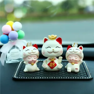 Detail shot of creative lucky cat and fortune baby car dashboard ornaments
