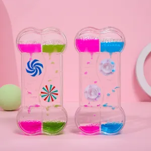 Vue détaillée du sablier liquide en forme d'os avec des gouttes d'huile colorées.