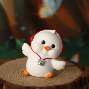Detailed view of a cute white duck figurine with red headphones on a natural wood stump