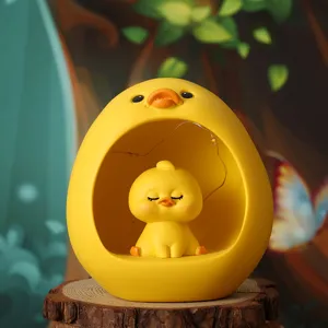 Close-up view of a cute cartoon duck resin night light with a glowing LED star light string