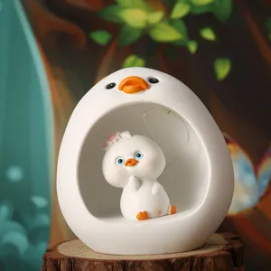 Close-up view of a cute cartoon resin duck ornament with internal LED star lights