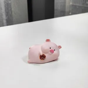 Cute pink resin pig figurine holding a donut for creative home desktop decoration