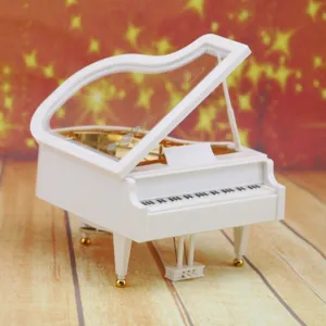 Elegant white piano-shaped music box with transparent lid for a creative birthday gift