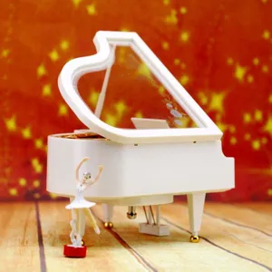 Elegant white grand piano music box with a rotating ballerina figurine gift idea