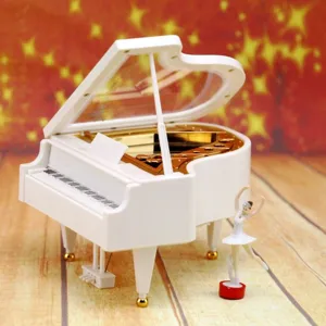 Detailed view of a white grand piano music box featuring a spinning ballerina figurine