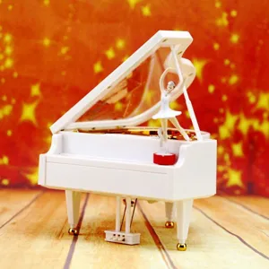 Elegant white grand piano music box with a rotating ballerina figurine