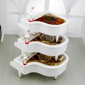 Elegant white piano shaped music box featuring a rotating ballerina girl for birthday gift