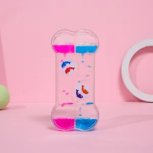 Primer plano detallado de un reloj de arena líquido con forma de hueso y gotas rosa azul
