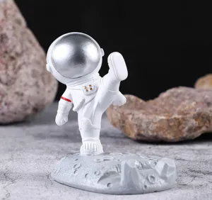 Vista lateral de un creativo soporte de resina para teléfono de astronauta en la luna