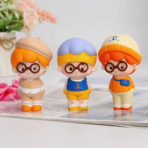 Close-up of three cute cartoon boy figurines with glasses and colorful outfits