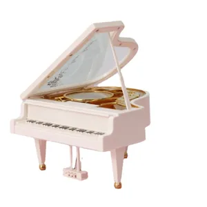 Élégante boîte à musique miniature piano à queue blanc avec accents dorés pour déco