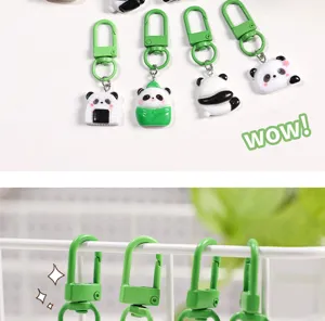 Cute cartoon panda keychain with green metal clasp, perfect schoolbag pendant and gift.