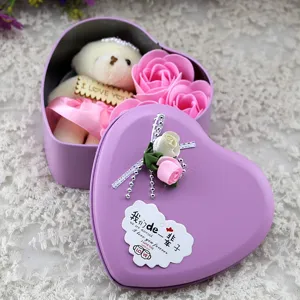 Detailed view of heart-shaped tin box with pink soap roses and a cute white plush bear