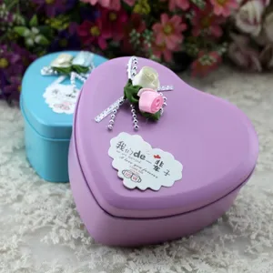 Close-up of purple heart-shaped tin gift box with decorative rose and silver beads