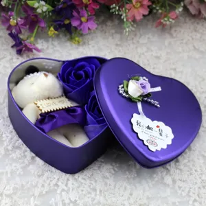 Detailed macro view of blue soap roses and teddy bear in heart-shaped purple tin box