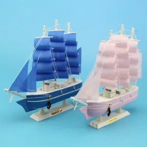 Detailed view of blue and pink Mediterranean style wooden sailing ship models