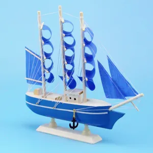 Macro detail of Mediterranean wooden sailing ship model with blue fabric sails and anchor
