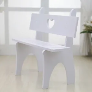 Detailed view of a white miniature wooden bench with a heart-shaped cutout for dolls
