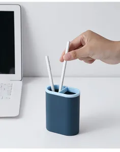 Dual compartment desk pen holder for office stationery storage and tidy desktop organization.