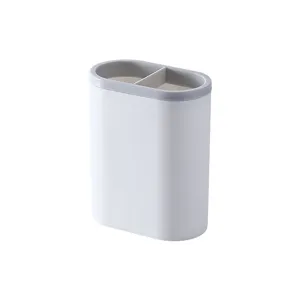 Dual compartment plastic pen holder for desktop stationery storage and office organization.