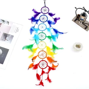 Rainbow feather dreamcatcher wall hanging decoration with lifestyle props on white surface