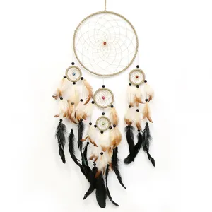 Handmade multi-ring dreamcatcher wall hanging with feathers and beads for home decor gift.