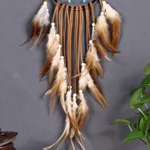 Detailed view of a bohemian brown feather dream catcher pendant with wood beads and leather cords.