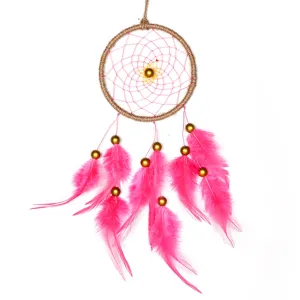 Detailed view of a handmade pink feather dreamcatcher with golden beads for home decor