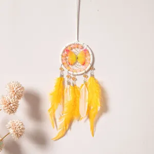Butterfly dream catcher car hanging ornament with colorful feathers and beads detail.