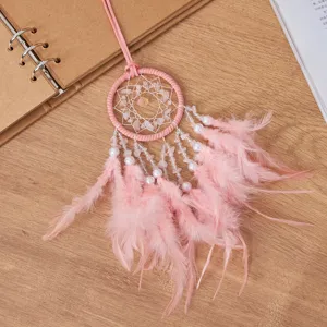 Pink feather dreamcatcher car hanging ornament with natural stones on wooden background