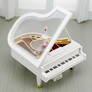 Elegant white grand piano music box featuring a rotating ballerina figurine inside