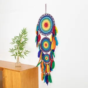 Detailed view of a vibrant colorful dream catcher with multi-layer woven rings and soft feathers.