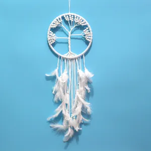 White tree of life dreamcatcher with hanging feathers decoration detail view