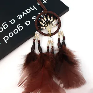 Brown tree of life dream catcher detail shot, featuring natural wooden beads and feather tassels.